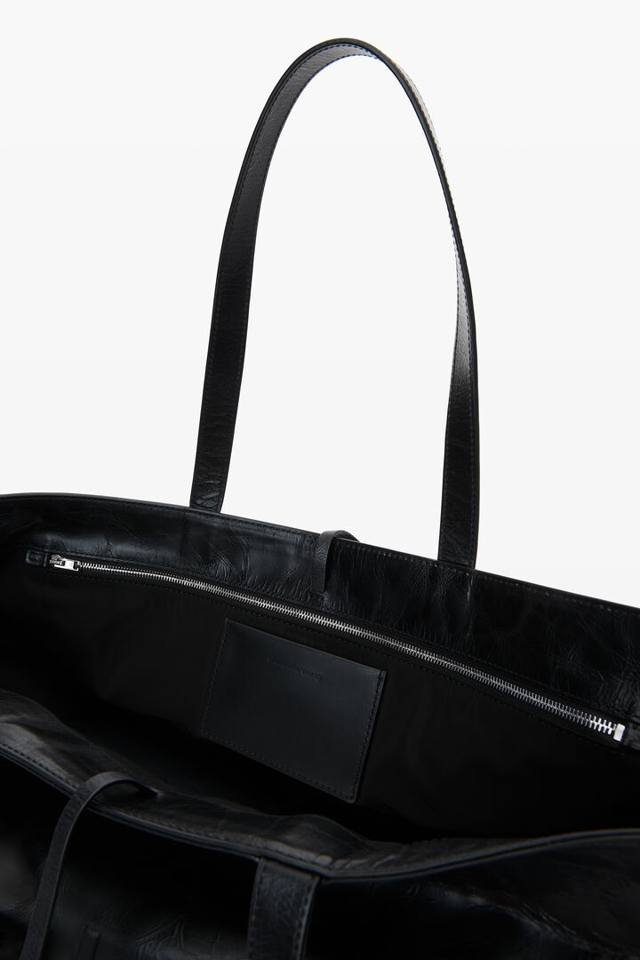 Black leather tote bag with textured logo